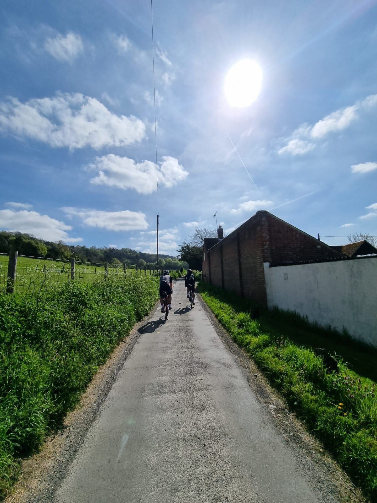 Cyclists on a quiet country lane on the London to Amsterdam cycling route through Flanders