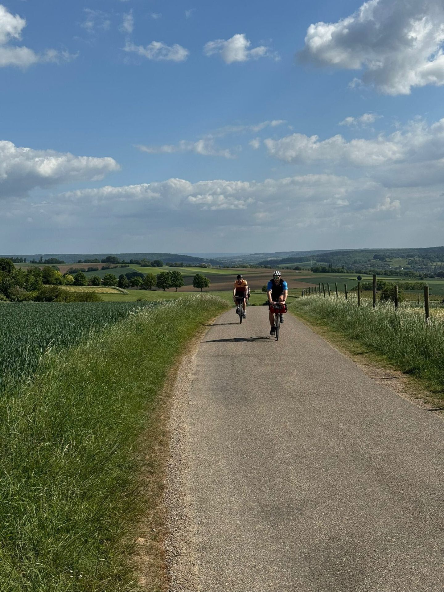 Cyclists climbing a Limburg lane on the Luxembourg to Amsterdam cycling route